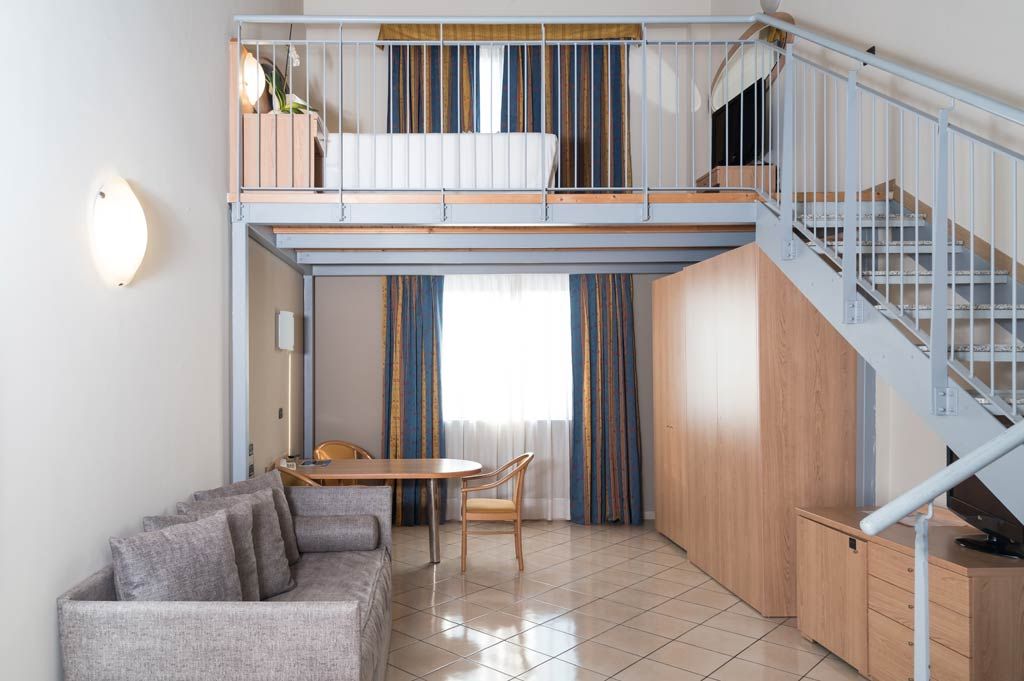 Two-level Junior Suite at Blu Hotel with sofa and staircase